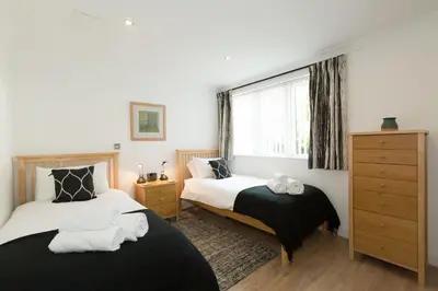 a bedroom with two beds and a window at The Point in St Ives