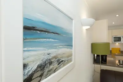 a painting of the ocean on a wall at The Point in St Ives