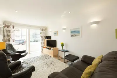 a living room with a couch and a tv at The Point in St Ives