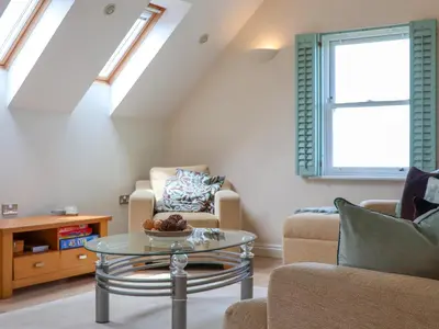 a living room with a table and two chairs at Celeste in Carbis Bay