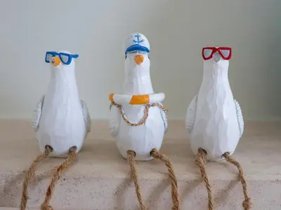three white plastic birds sitting on a table at Celeste in Carbis Bay