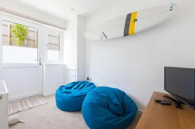 a room with a surfboard hanging on the wall at Hebaska in Carbis Bay