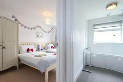 a hospital room with two beds and a window at St Ives Bay View in Carbis Bay