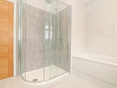 a shower with a glass door in a bathroom at Boscregan in Helston