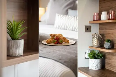 a hotel room with a plate of food on a bed at Number Four - Piran View in Padstow