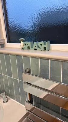 a shelf with a flash sign next to a sink at Lake View Lodge in Saint Columb Major