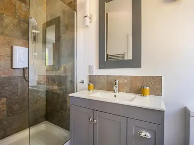a bathroom with a sink and a shower at Bay Tree in Crackington Haven
