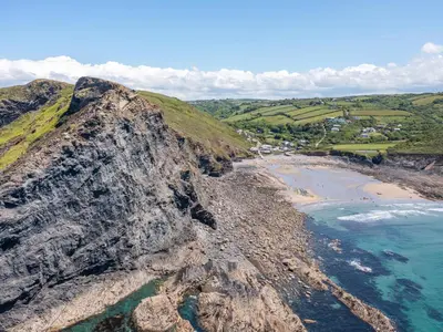 an aerial view of the ocean and a rocky beach at Bay Tree in Crackington Haven