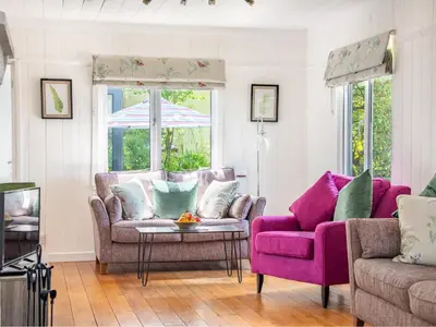 a living room with a couch and a chair at Bay Tree in Crackington Haven