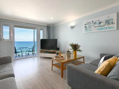 a living room with a view of the ocean at Ivory in St Ives
