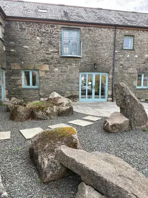a stone building with rocks in front of it at The Mill'ouse in Launceston