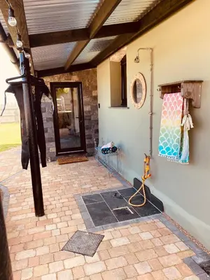 a room with a patio with a door and a wall at Sea View at Widemouth Bay - 3 bedroom cottage in Poundstock