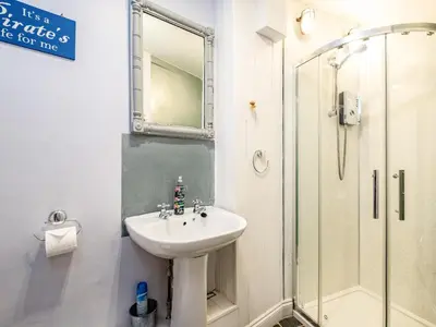 a bathroom with a sink and a shower at Pibbies in Port Isaac
