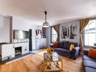 a living room with a couch and a fireplace at Pibbies in Port Isaac