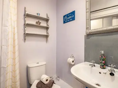 a bathroom with a toilet and a sink at Pibbies in Port Isaac