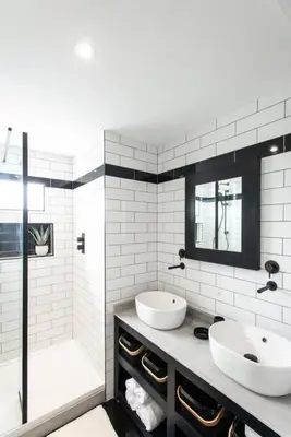 a bathroom with two sinks and a shower at 10 Boskenza Court in Carbis Bay