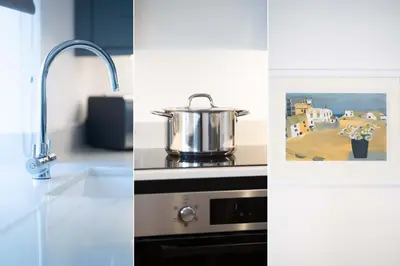 a pot sitting on top of a stove in a kitchen at Karibu - Boutique Cottage with Parking - Short walk to Beach in St Ives