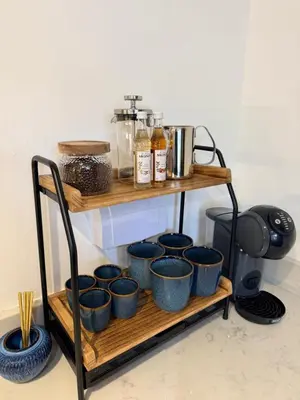a shelf with blue cups on top of it at Karibu - Boutique Cottage with Parking - Short walk to Beach in St Ives