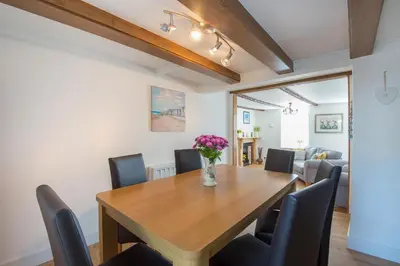 a dining room with a wooden table and chairs at Meledor in Marazion