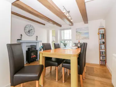 a dining room with a wooden table and chairs at Meledor in Marazion