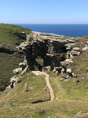 a rock formation on a hill next to the ocean at Little Valley View in Otterham