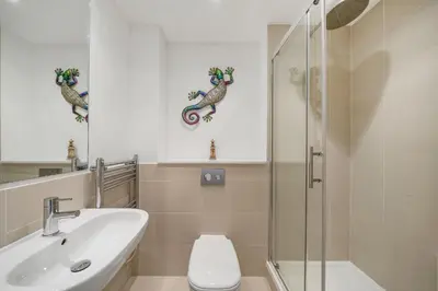 a bathroom with a sink toilet and a shower at 5 The Dunes in Perranporth