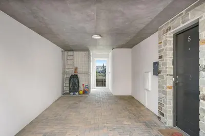 a hallway of a house with a brick wall at 5 The Dunes in Perranporth