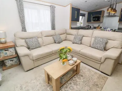 a living room with a couch and a coffee table at Chantry Lodge in Newquay