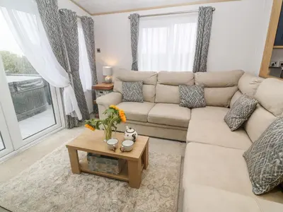 a living room with a couch and a coffee table at Chantry Lodge in Newquay