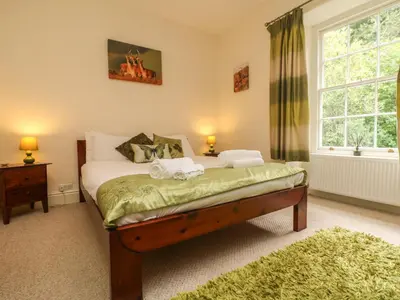 a bedroom with a bed with two towels on it at Gweek House in Helston