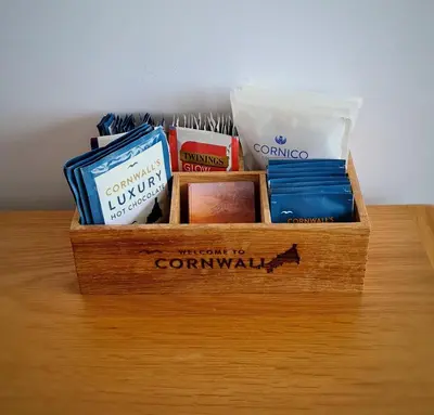 a wooden box filled with items on a table at Sirens Sunset Peaceful Retreat with stunning sea views, 5 minutes from Porth Beach in Newquay