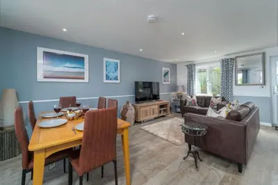 a living room with a table and a couch at Blue Water in St Ives
