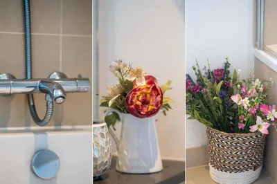 a vase of flowers sitting on a counter next to a sink at Blue Water in St Ives