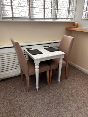 a table and two chairs in a room at Shazzamm in Newquay