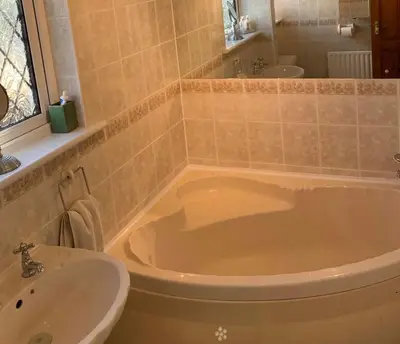 a bathroom with a tub and a sink at Shazzamm in Newquay