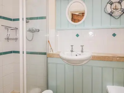 a bathroom with a sink and a shower at Dovecote in Saint Goran