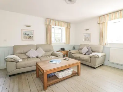 a living room with two couches and a coffee table at Owls Roost in Saint Goran