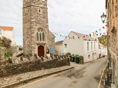 a street in front of a church with flags at Owls Roost in Saint Goran