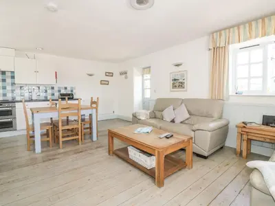 a living room with a couch and a table at Owls Roost in Saint Goran