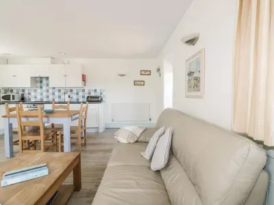 a living room with a couch and a table at Owls Roost in Saint Goran