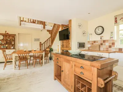 a kitchen and dining room with a table and chairs at Foxes Den in Saint Goran