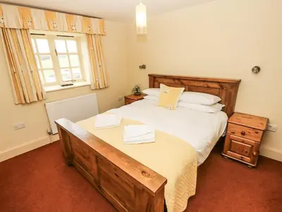 a bedroom with a large bed and a window at Foxes Den in Saint Goran