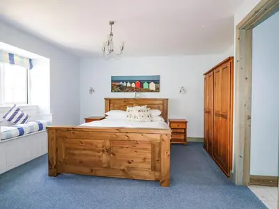 a bedroom with a large wooden bed in a room at Squirrels Dray in Saint Goran