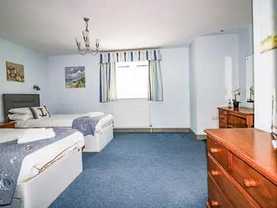 a bedroom with two beds and a window at Squirrels Dray in Saint Goran