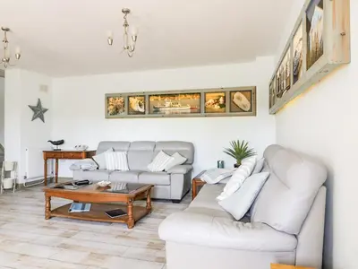 a living room with a couch and a table at Squirrels Dray in Saint Goran
