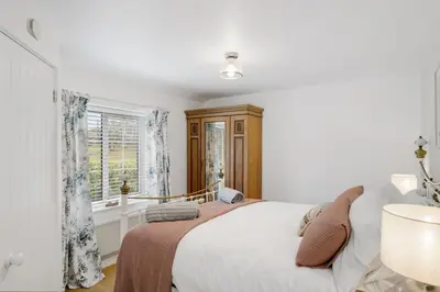 a bedroom with a bed and a window at Jade Cottage in St. Agnes