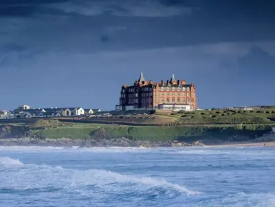 a large building on a cliff next to the ocean at Ocean Gate in Newquay