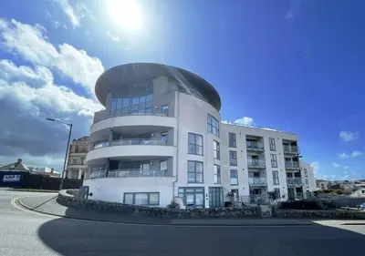 a white building with a dome on top of it at Ocean Gate in Newquay