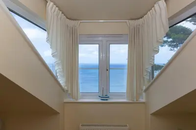a window with a view of the ocean at Ocean Gem in Carbis Bay