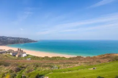 a view of a beach with a house and the ocean at Golden Heights in Carbis Bay